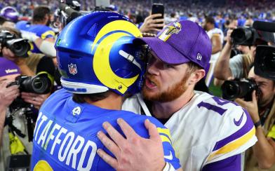 Matthew Stafford and Sam Darnold hug